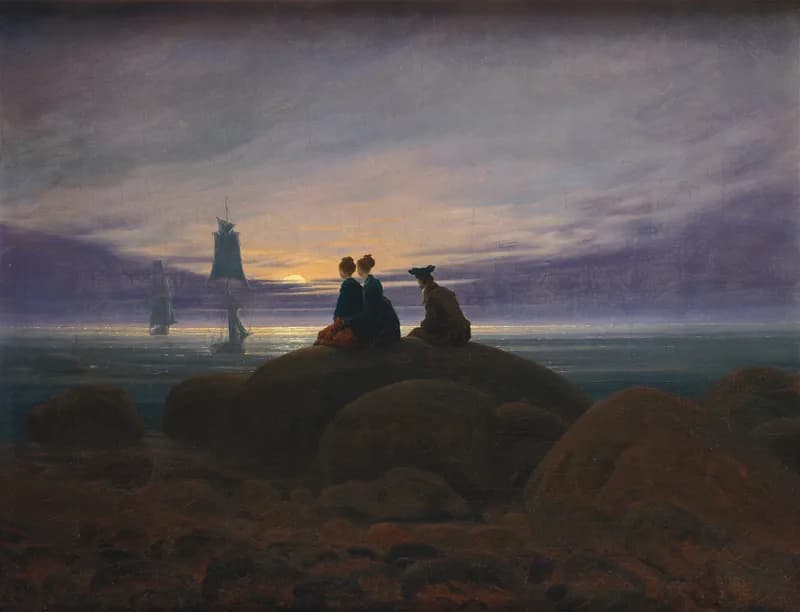 Oil painting Moonrise over the Sea by Caspar David Friedrich, showing three figures on rocks by the shore watching sailing ships at twilight